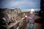 A worker unloads a chain to complete a hydro-test job from a truck built by Luft Machine in Sterling, Colo.
