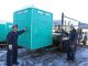 Matt Wortman (left) and Mike Slocum load a handicap accessible unit from PolyPortables onto the truck.