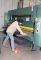 Dartanian Brown, an employee for Key Welding, loads the Betenbender press brake with a sheet of metal that the machine will bend.