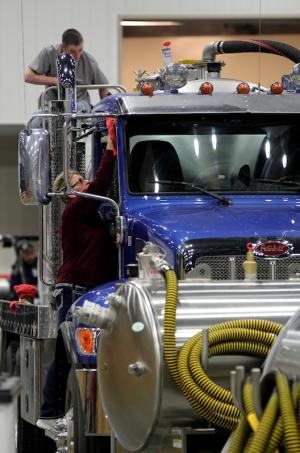 A crew from K-Rae Transportation out of Illinois works on polishing a vacuum truck on Tuesday during setup of the WWETT Show.