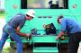 Josh McCoy, right, and Nicholas Henney set up equipment on a new wireline truck at the company’s shop in Elmendorf, Texas.
