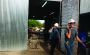 Nicholas Henney, front, and Josh McCoy carry equipment from Bullzeye Oilfield Services’ shop to a field truck before dispatching it to a job site nearby.