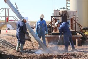 A C Company crew performs hydroexcavation work on an oil drilling side near Williston, North Dakota. The company has had to lay off some of its workforce as the oil prices have dropped.