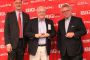 Dan Miller (left), president and CEO of Manitou Americas, and Francois Piffard (right), executive vice president of sales and marketing for Manitou Group, present the 2015 Manitou Top Dealer Award to Pete Smeretsky of Transport Equipment Sales.